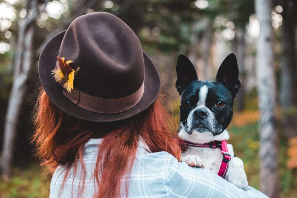 Woman carrying a puppy