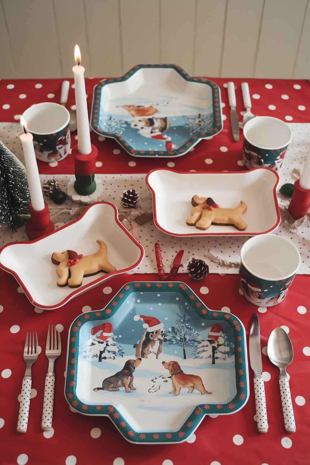 A festive table setting with dog-themed plates, cups, and decorations for Christmas.