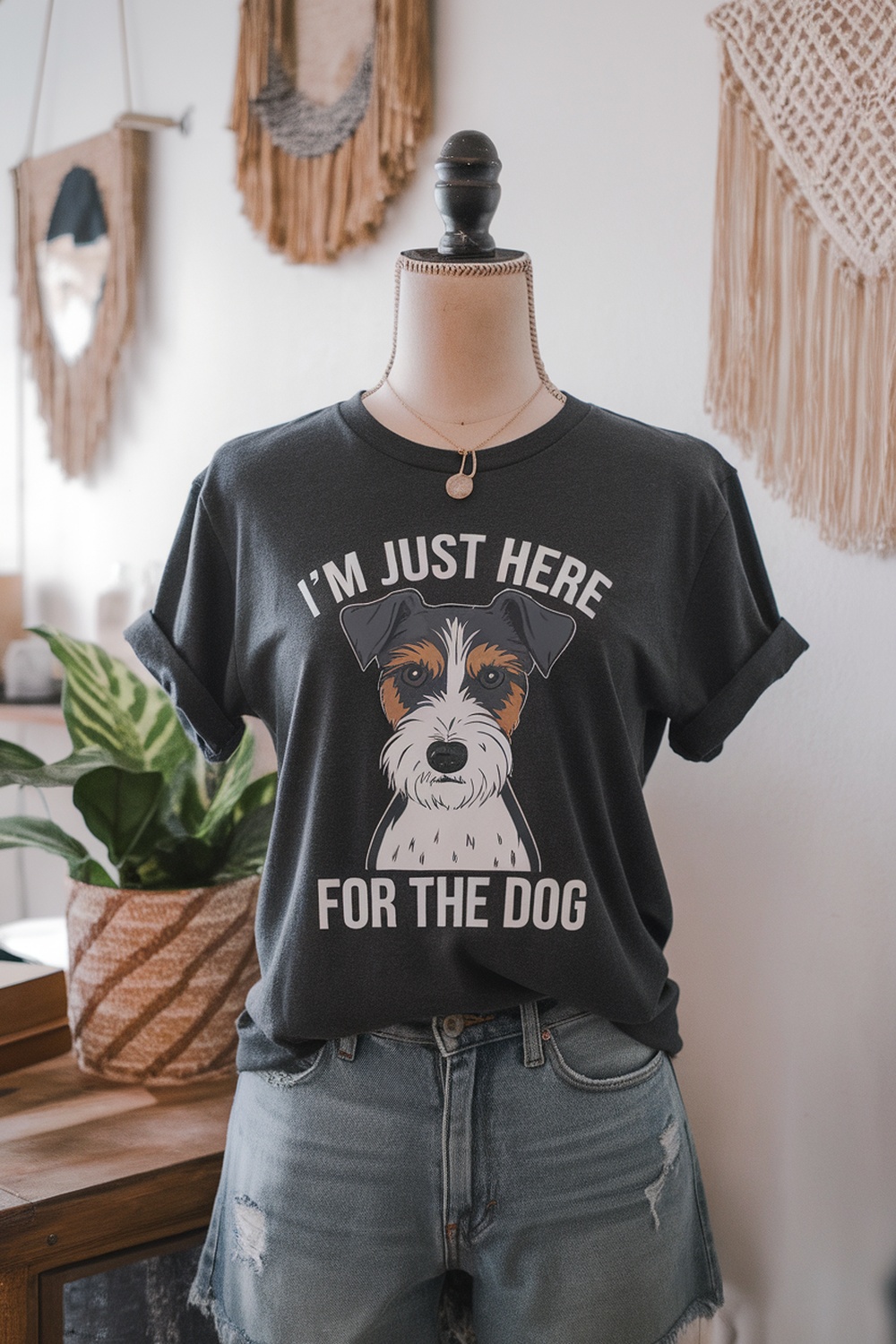A black t-shirt with a terrier graphic and the text 'I'm just here for the dog.'